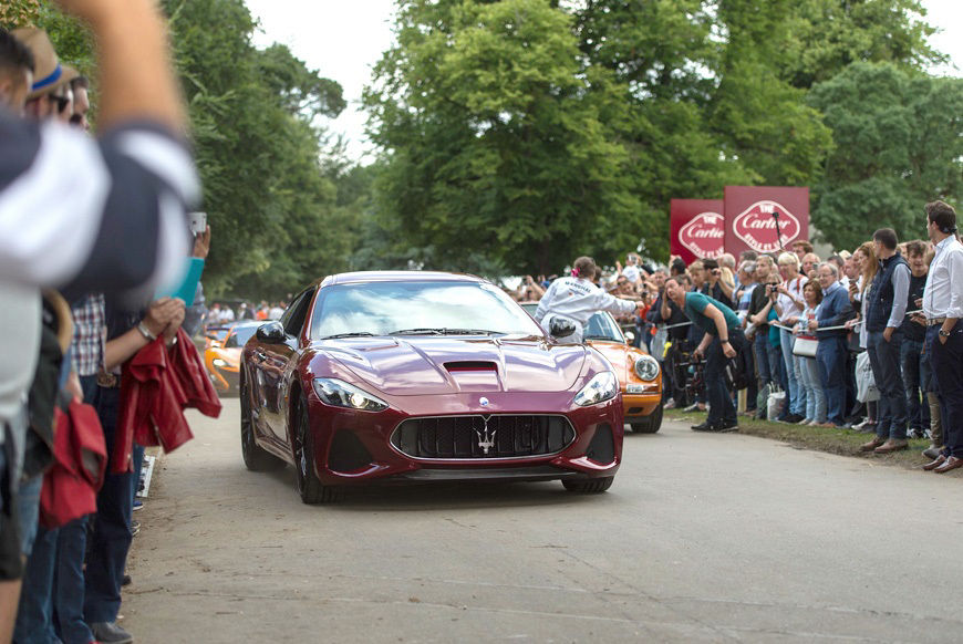 Maserati GranTurismo at Goodwood Festival riding in front of people lined up