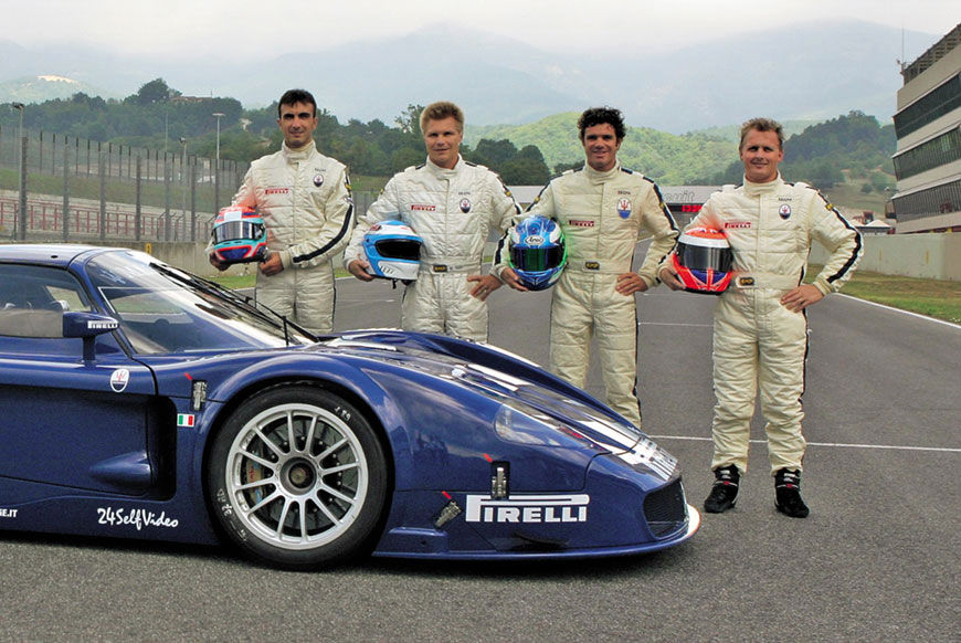 Johnny Herbert and his racing team in front of MC12