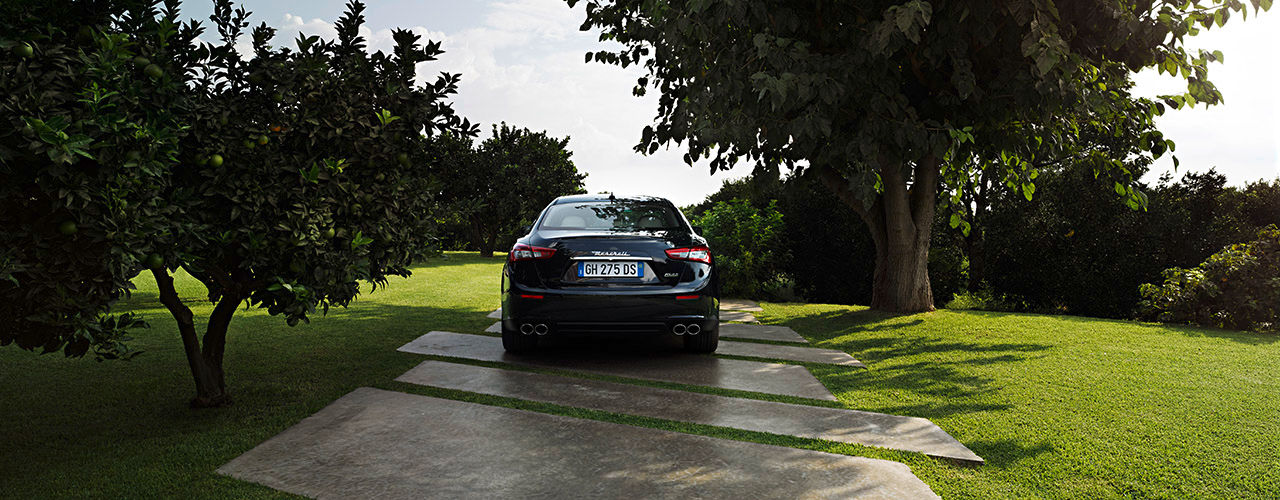 Rear view of Maserati in a garden