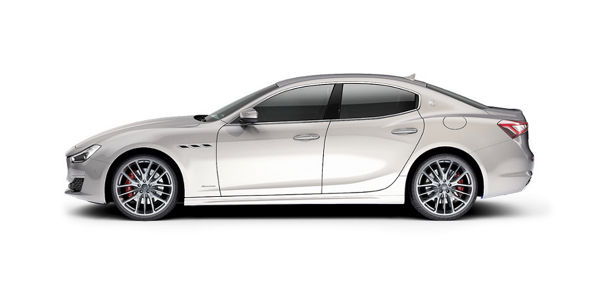 Side view of a white 4 door Maserati Ghibli