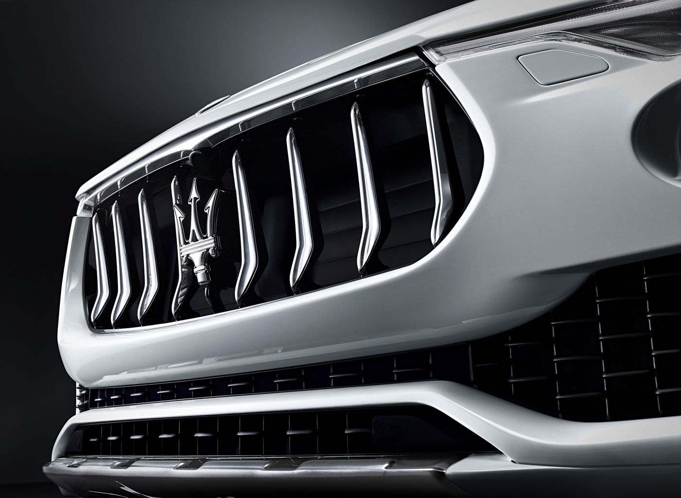 Logo on white Maserati Levante - Luxury SUV - Side front view