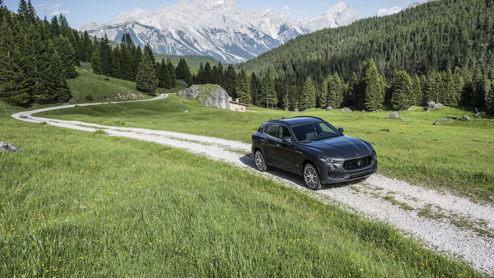Maserati Levante driving in a mountains landscape - air suspension technology