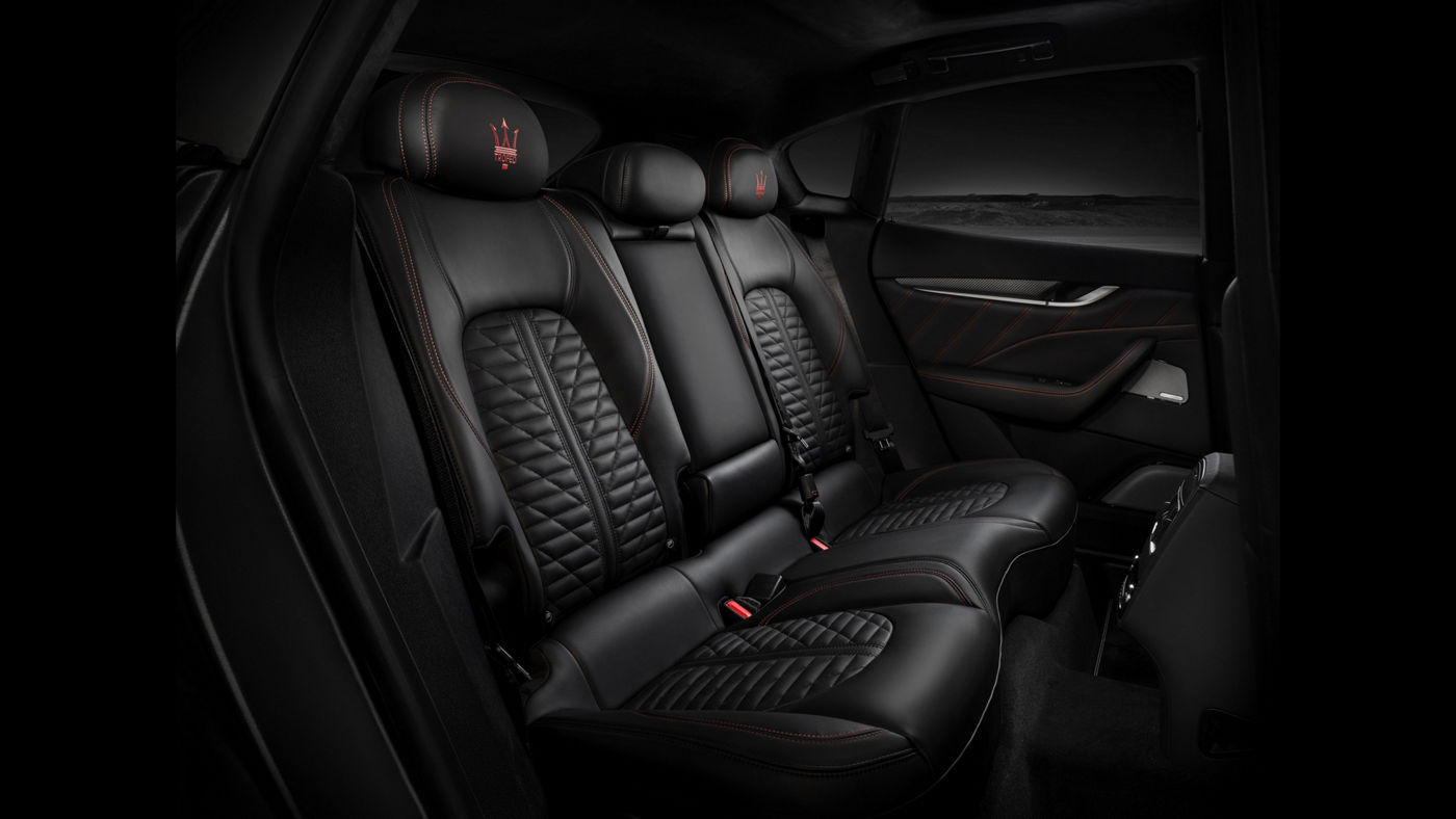 Maserati Levante Trofeo V8 - interior details: rear seats with black leather and red stitching