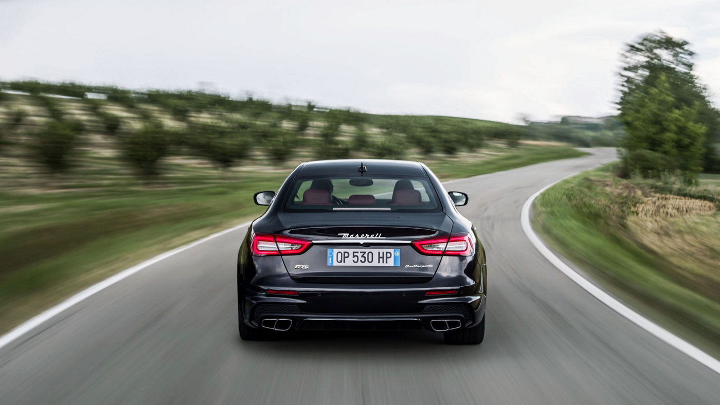Rear view of a black Maserati Quattroporte driving in countryside - Limited-Slip Differential technology