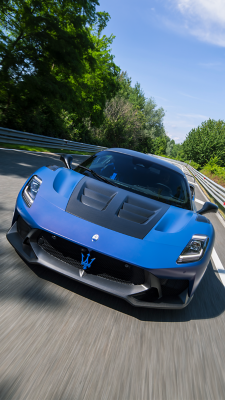 Blue Maserati GT2 Stradale moving on the left side of the lane