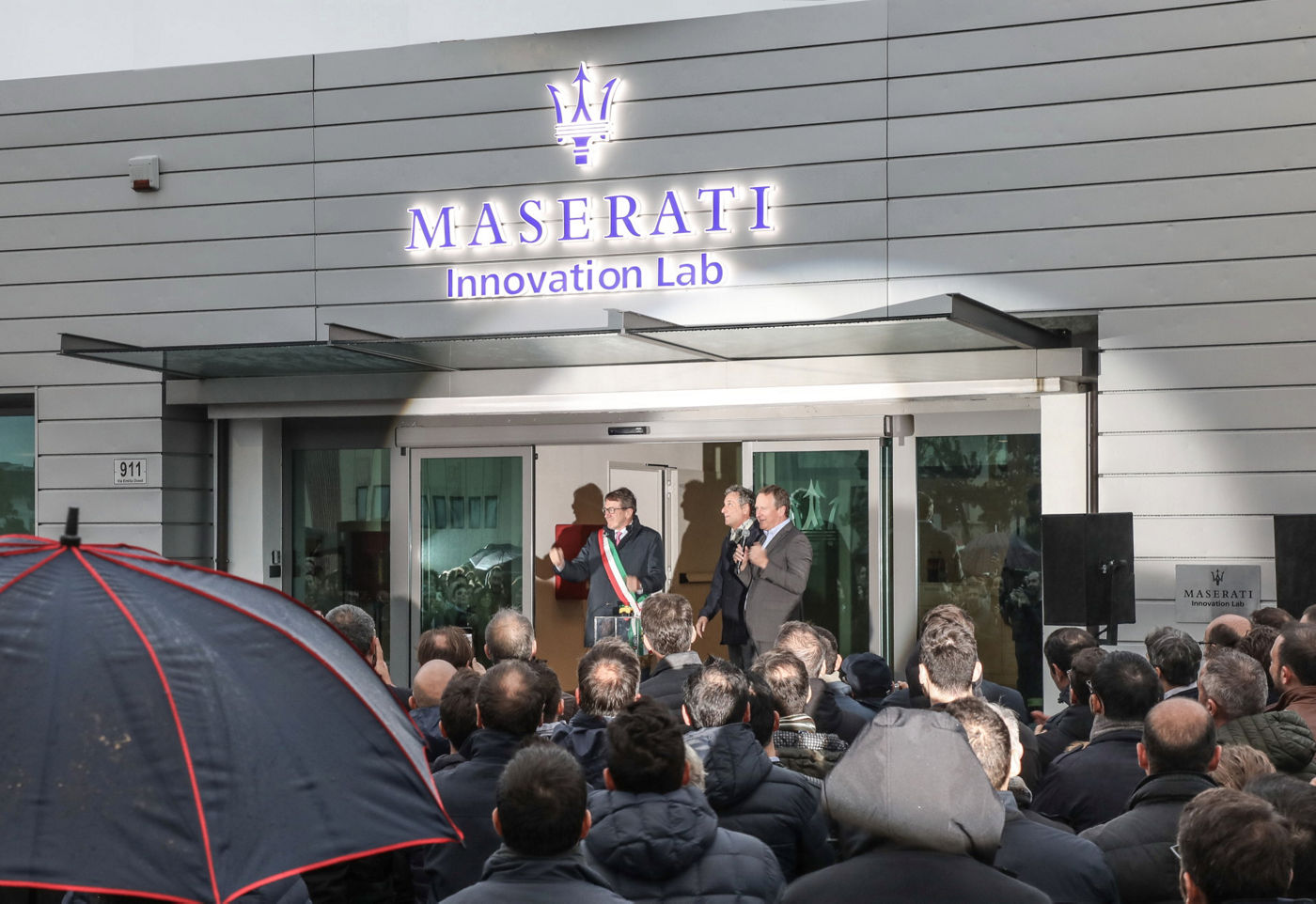 Maserati Innovation Lab with many people outside 