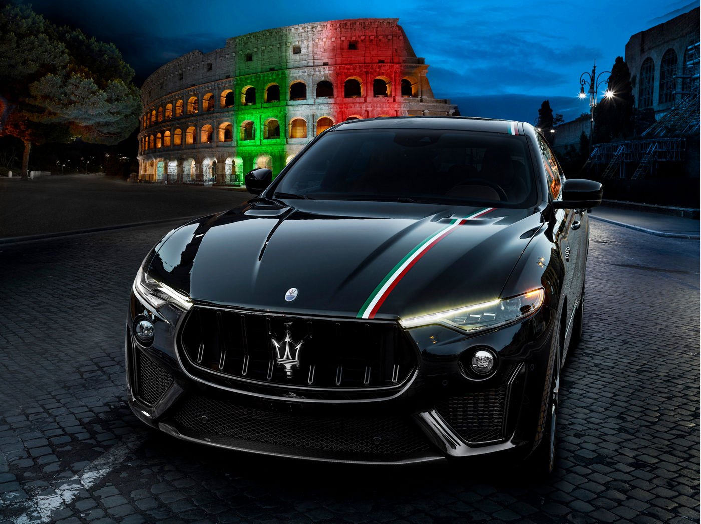 Maserati Levante Trofeo with Italian tricolor band, front view, in front of the Colosseum in Rome