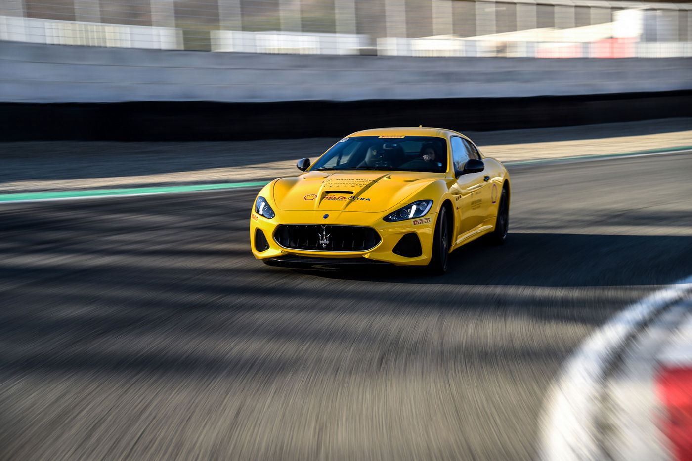 Yellow Maserati model on the Varano track