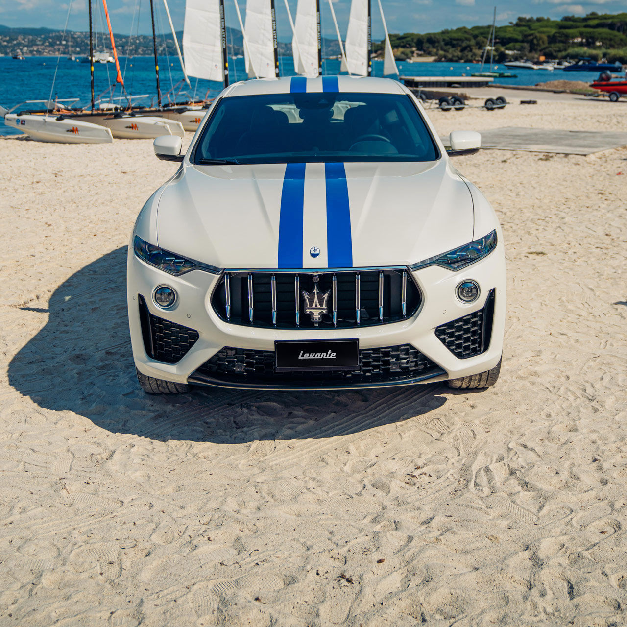 Frontal view of Maserati Levante Hybrid on Saint Tropez beach