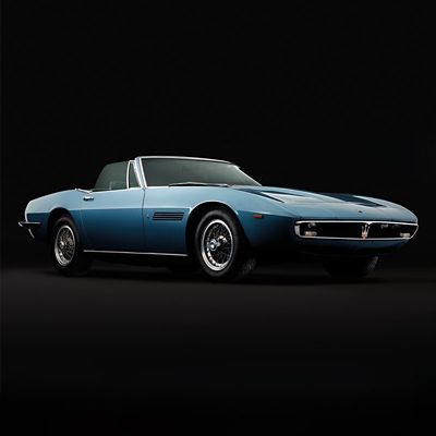 Vintage Maserati Ghibli Spyder viewed from the front right side on an abstract black background