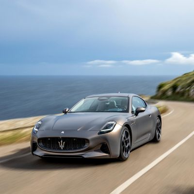 A gray Maserati GranTurismo Folgore moving on a coastal road