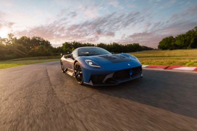 Maserati GT2 Stradale on the track at sunset while taking a bend