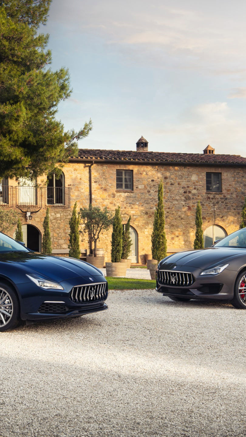 Maserati Quattroporte S and GTS parked in front of an Italian villa