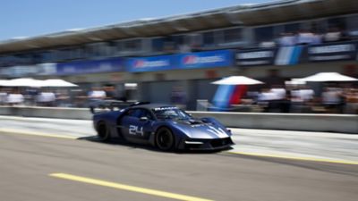 Maserati MCXtrema at Laguna Seca, with dark blue livery, stylized trident on the front bonnet and number 24 stamped on the right side