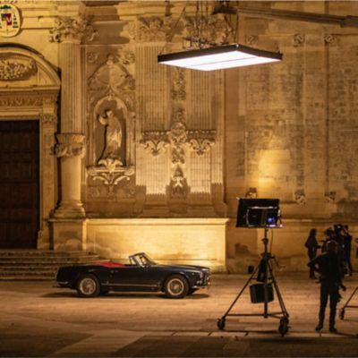 A vintage Maserati 3500 GT spyder car in front of a peculiar baroque church on the set of the short film 'Companions of Travel' shot by Ozpetek in Puglia, southern Italy, for Maserati.