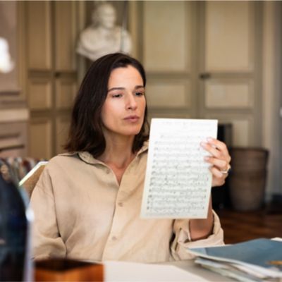 Actress holding a sheet of music during the filming of the short film "Companions of Travel" shot by Ozpetek in Puglia for Maserati.