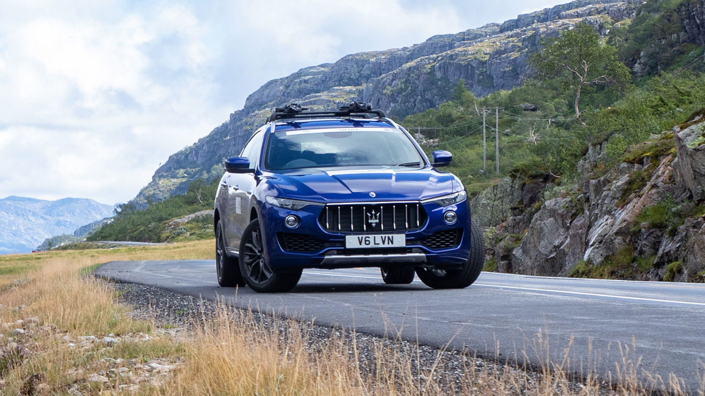 A Maserati Levante SUV runs an uphill Norwegian road