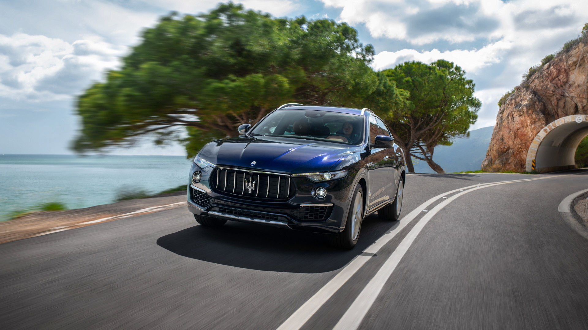 The luxury SUV Maserati Levante 2019 on the road - front view