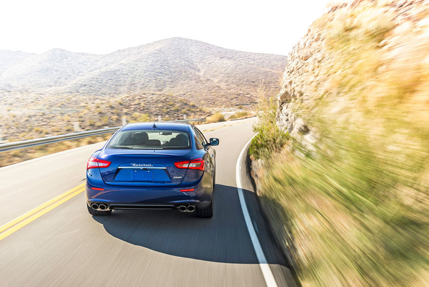 Blue Masera Quattroporte - Sedan - Back view - On the road