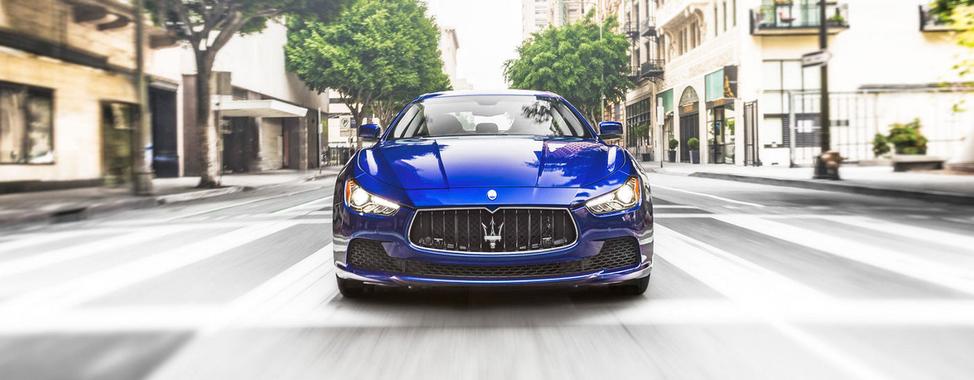 Blue Maserati Quattroporte - Sedan - Front view - On the road