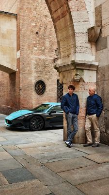 father-and-son-ferrua-under-an-arch-with-mc20-behind-mobile