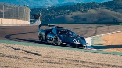 Gabriele Vignaroli tackles the Laguna Seca Corkscrew in a new dark blue racing Maserati MCXtrema