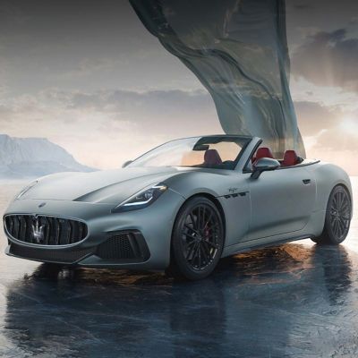 Grey Maserati GranCabrio photographed outdoors with a drape behind it