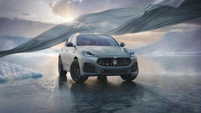 The Maserati Grecale SUV designed by Maserati Fuoriserie photographed in a frozen landscape with a drape behind it