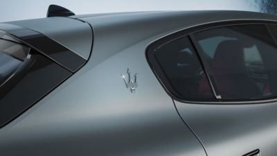 Symbol of the Maserati Trident in relief on the bodywork of the slate grey Grecale