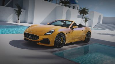 Yellow GranCabrio Trofeo convertible by serene pool.