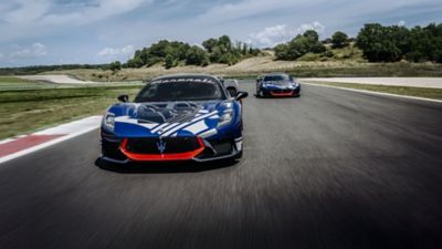 maserati-driving-experience-two-cars-running-on-the-circuit-front-view-desktop